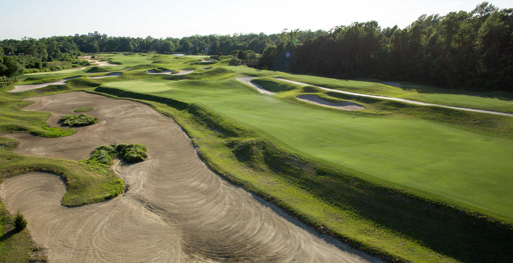 Golf course aerial with sculpted bunkers